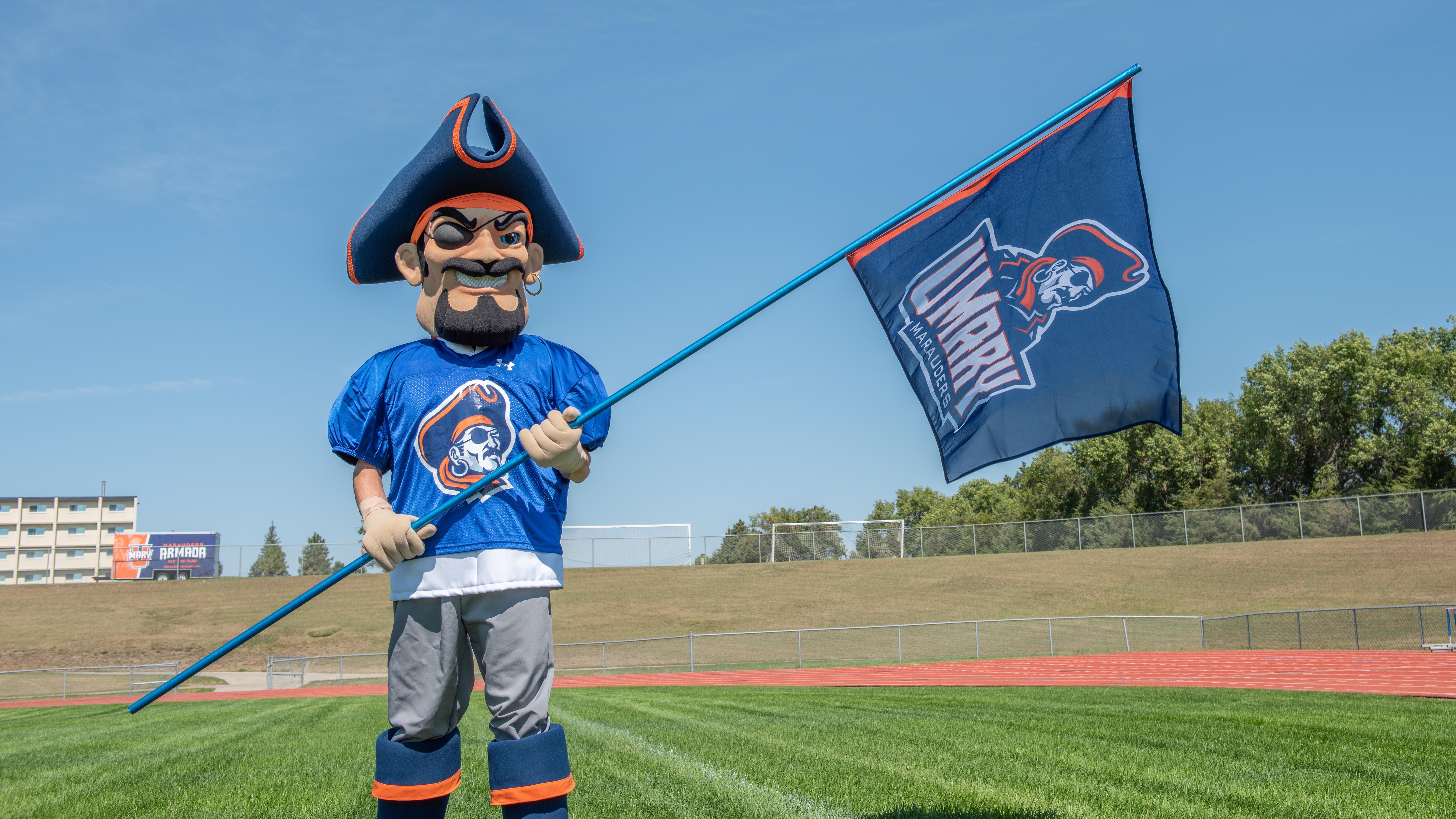 Max the Marauder holding the UMary athletics flag