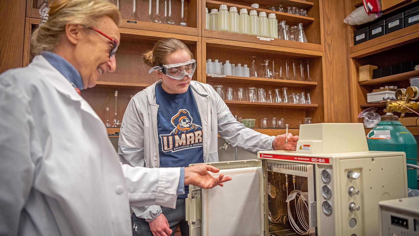 Student and professor working on a project.