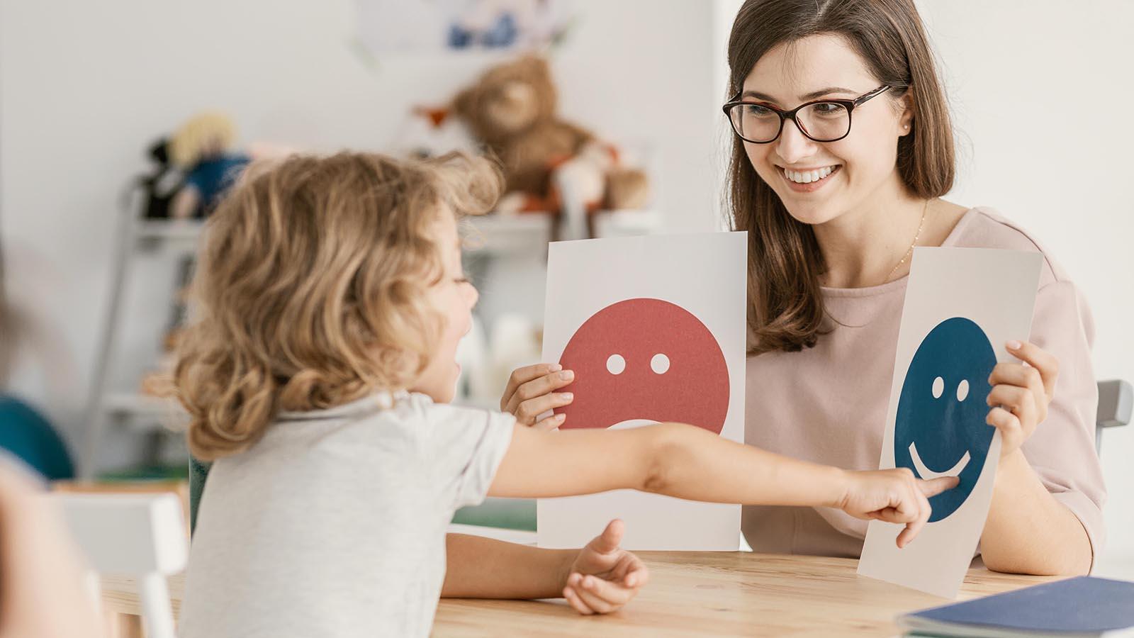Emotion emoticons used by a school counselor during a therapy session with a child.