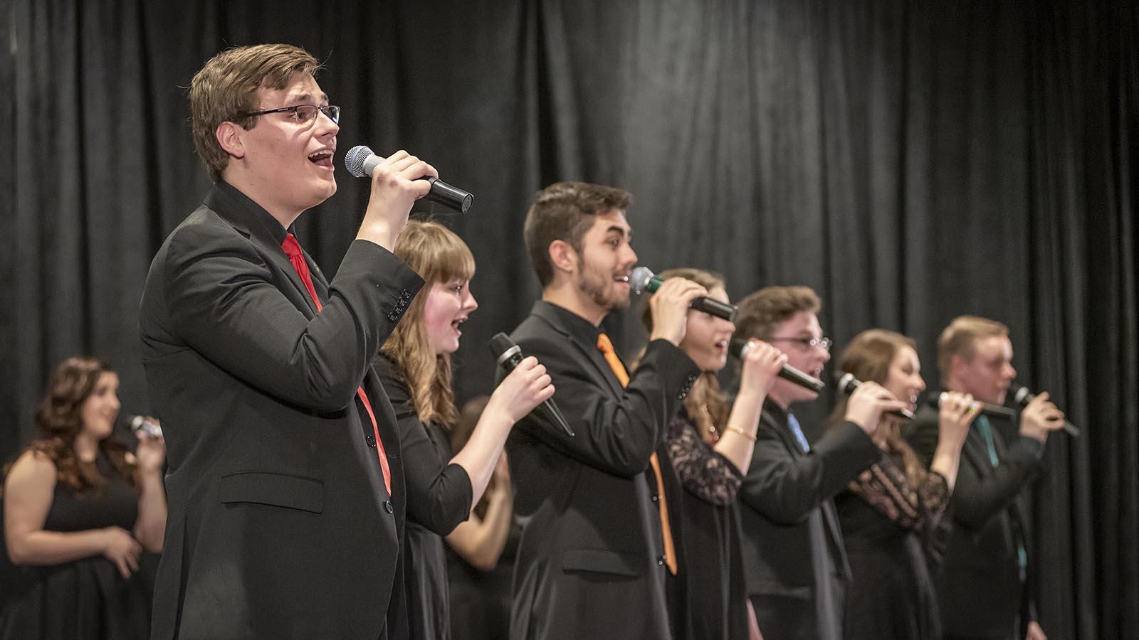 Eight jazz singers perform for an audience.