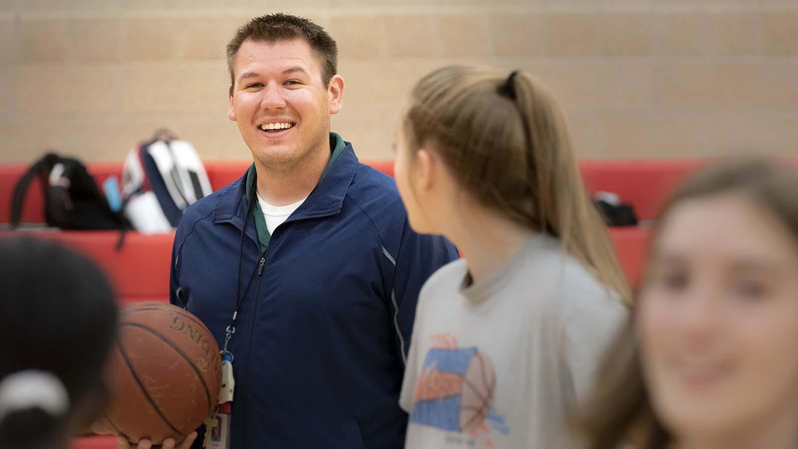 Man coaching high school basketball practice