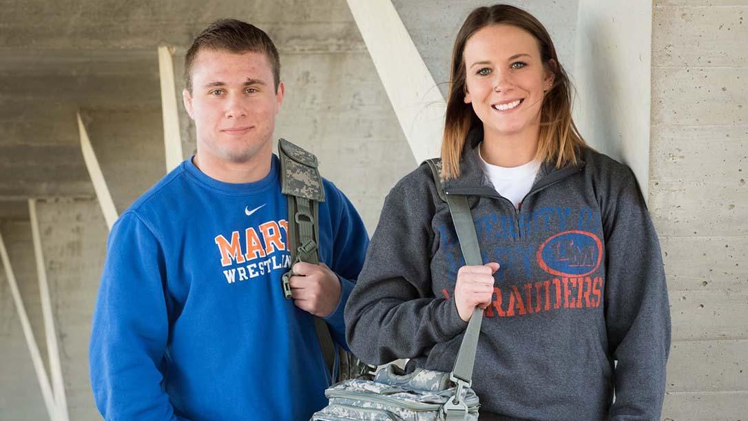 Two smiling military students carrying camouflage backpacks