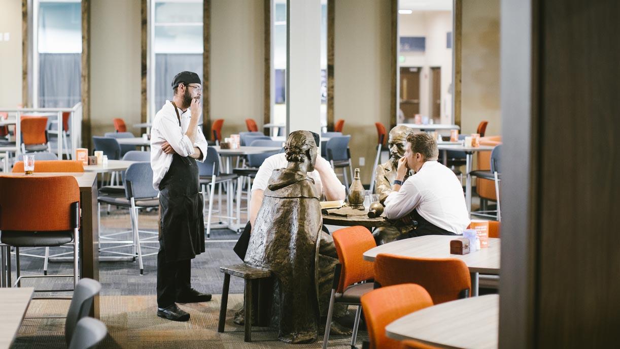 Three University of Mary chefs having a discussion in the Crow’s Nest Campus Restaurant.