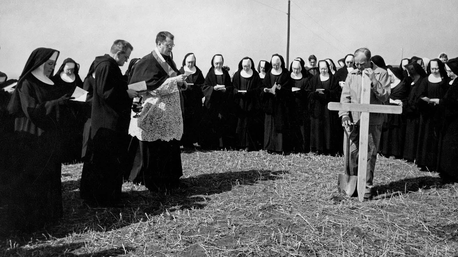 Photo of historic Mary community gathered together to install original wooden cross