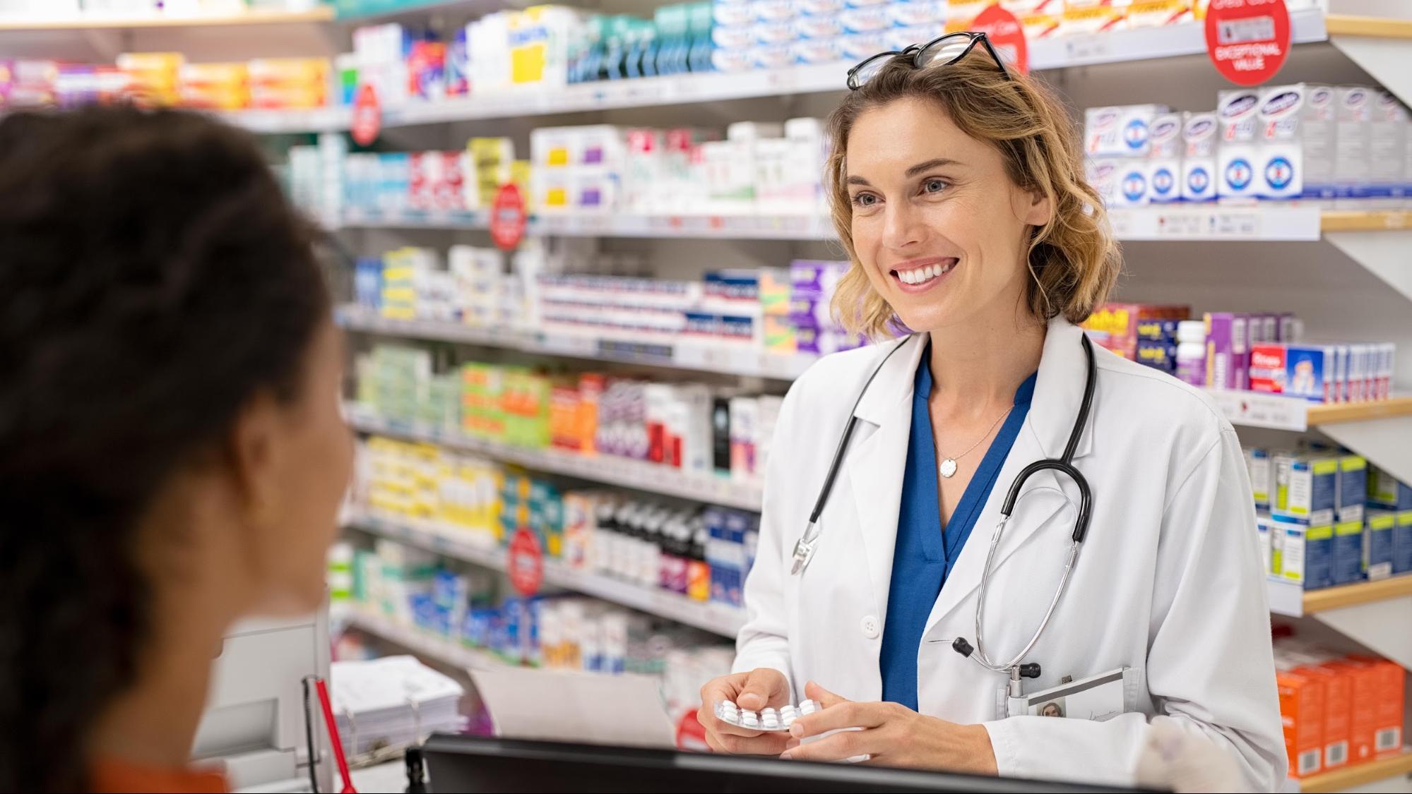 Pharmacist talking with customer