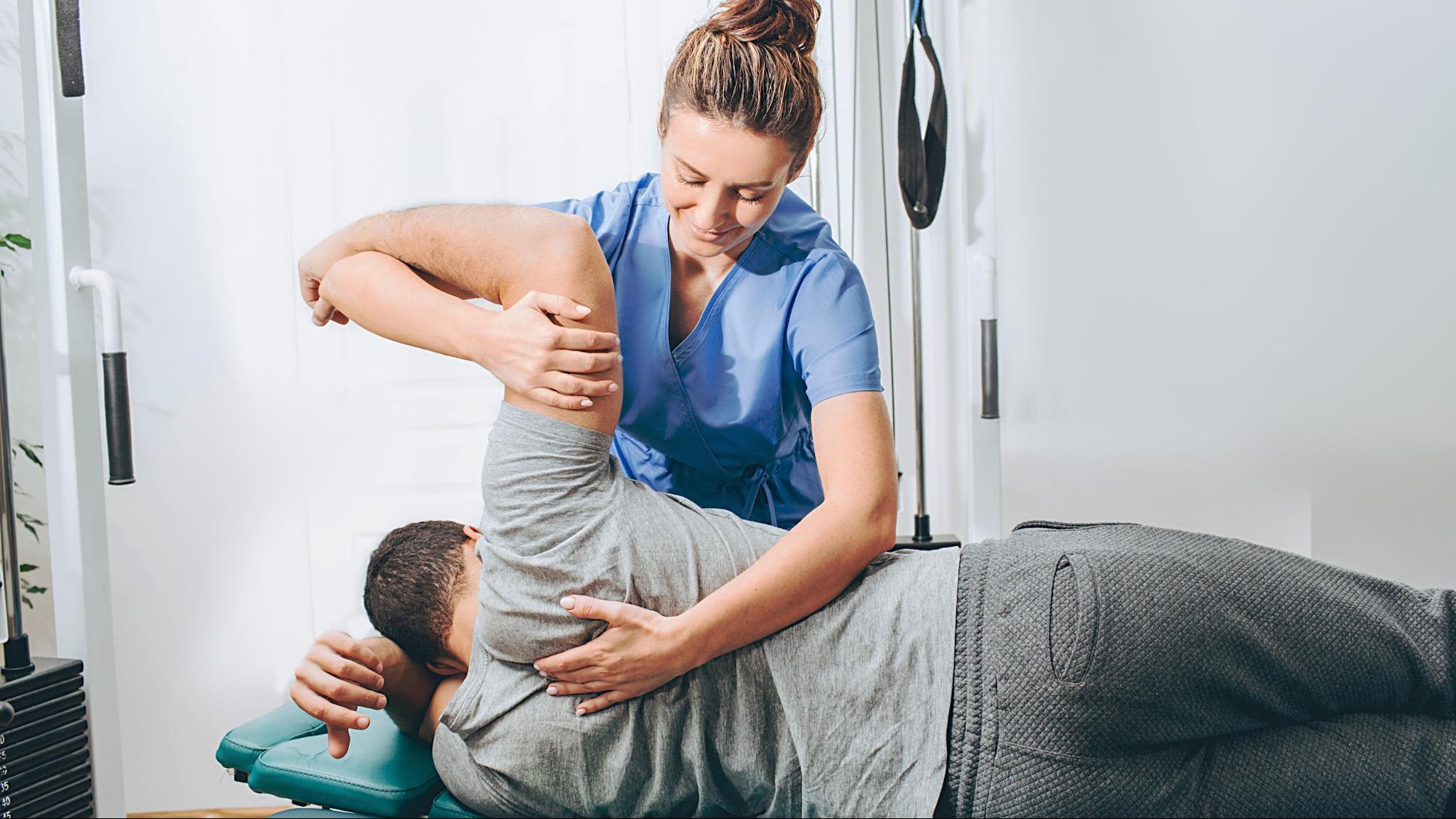 Chiropractor working with patient