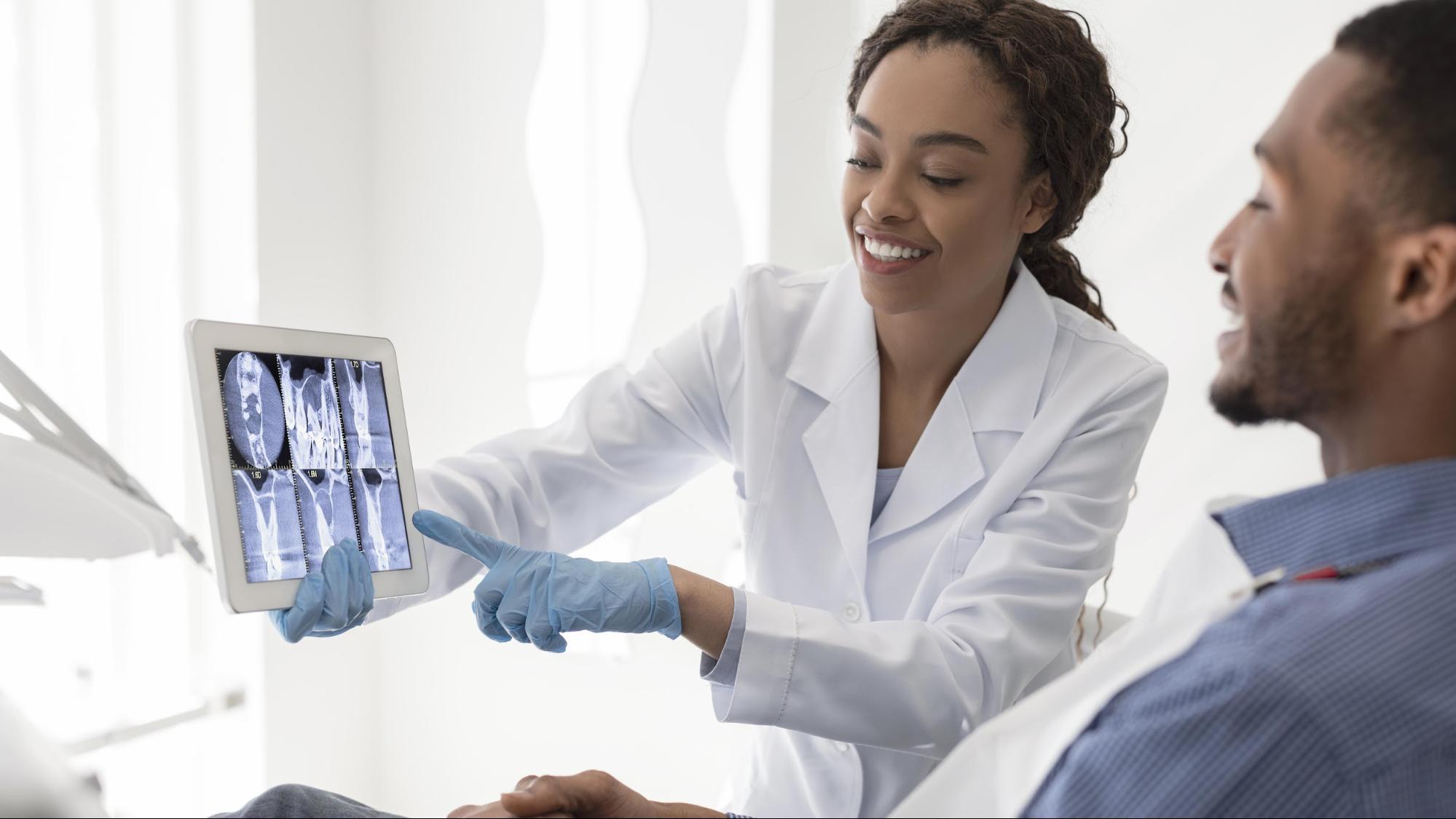 Dentist showing x-rays to a patient.