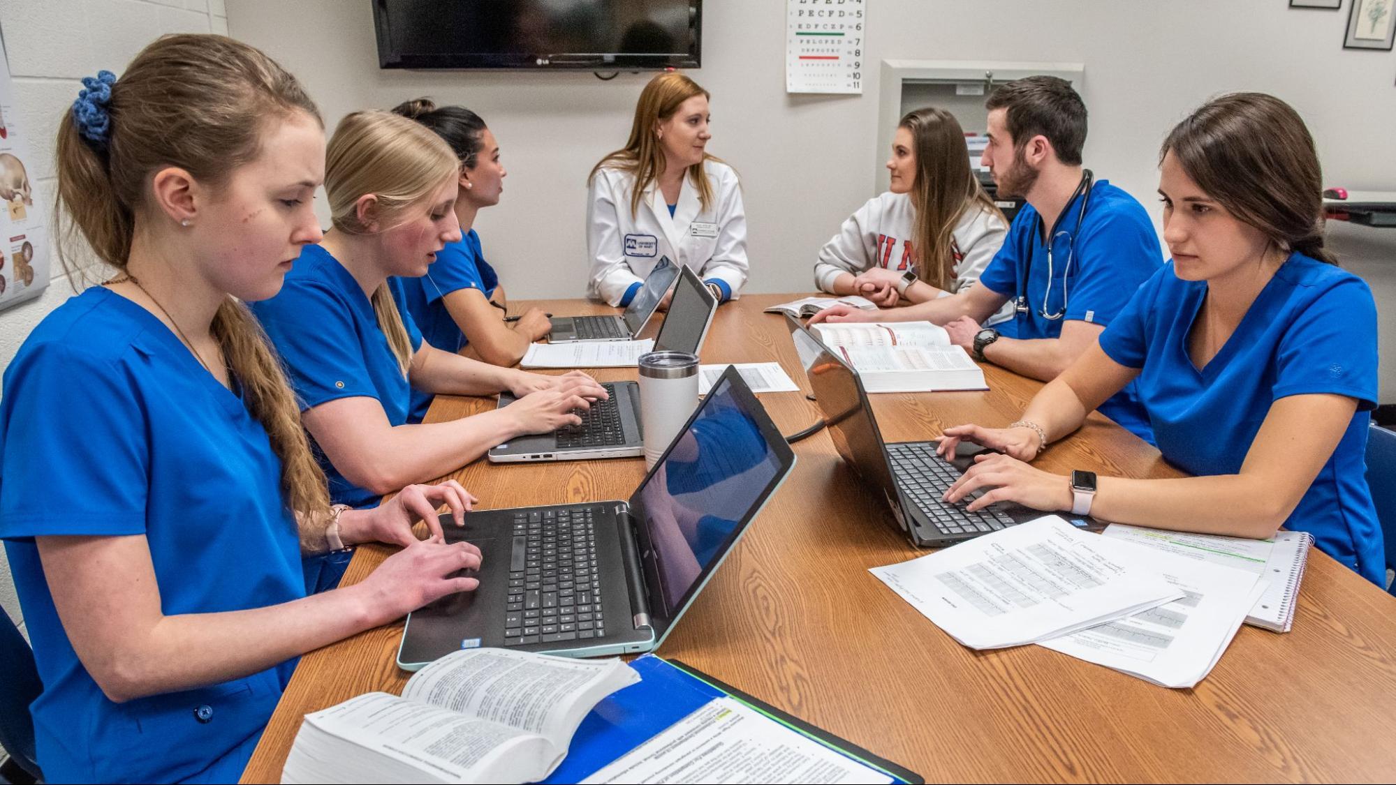 Group of nurses studying in their scrubs.