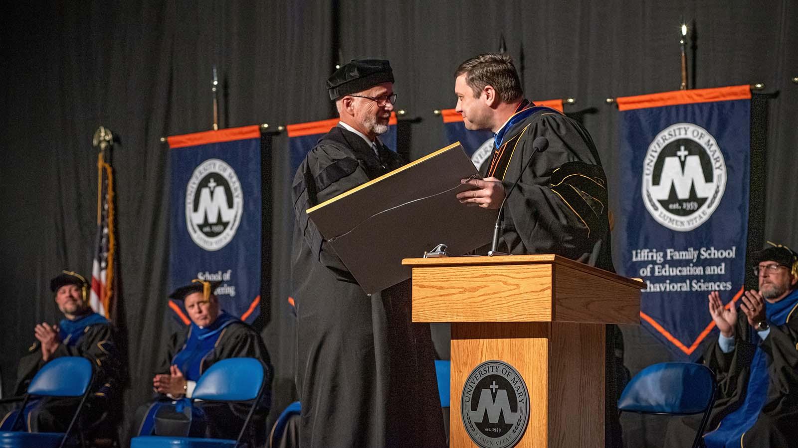 Monsignor giving an Honorary doctorate