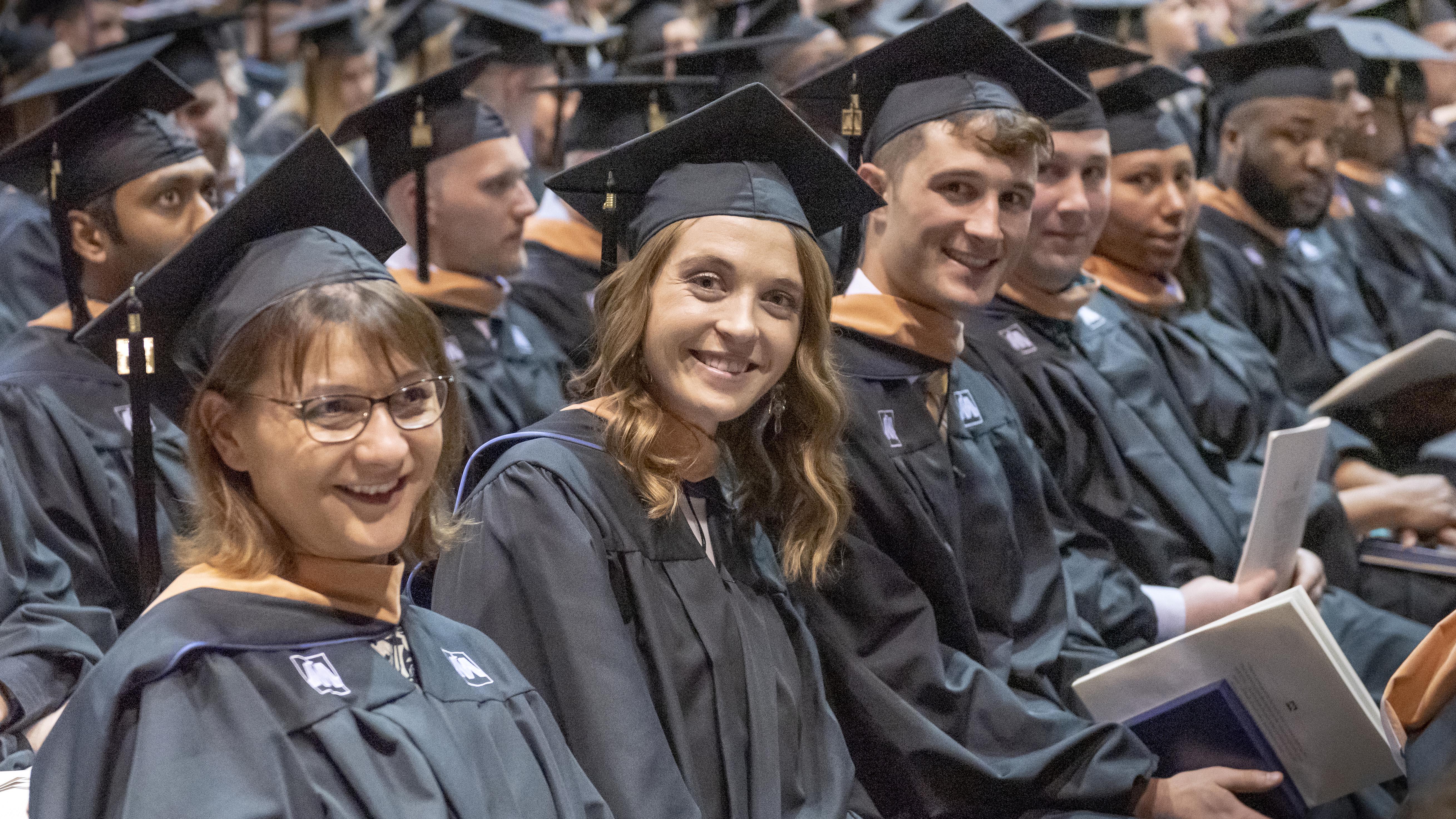 University of Mary graduates smiling during commencement.