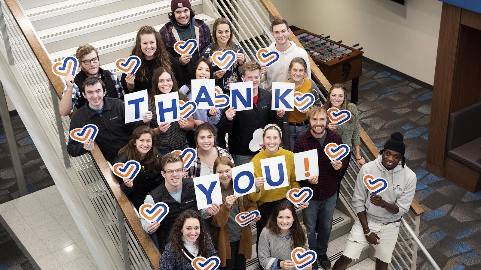 Group of University of Mary students holding letters that spell out “thank you!”