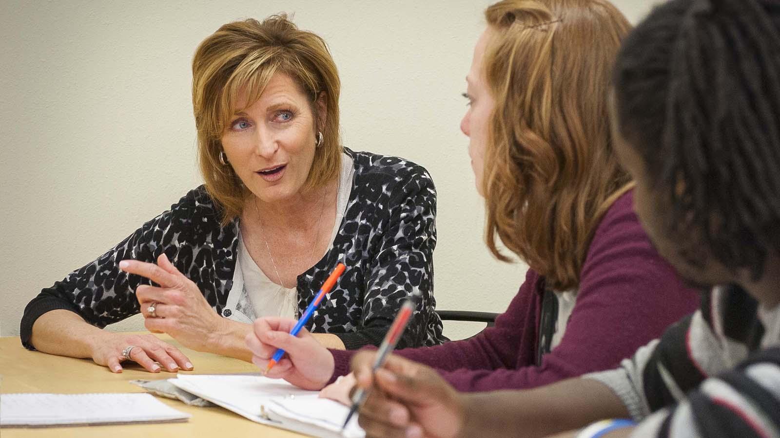 Professor Brenda Tufte engaged with students