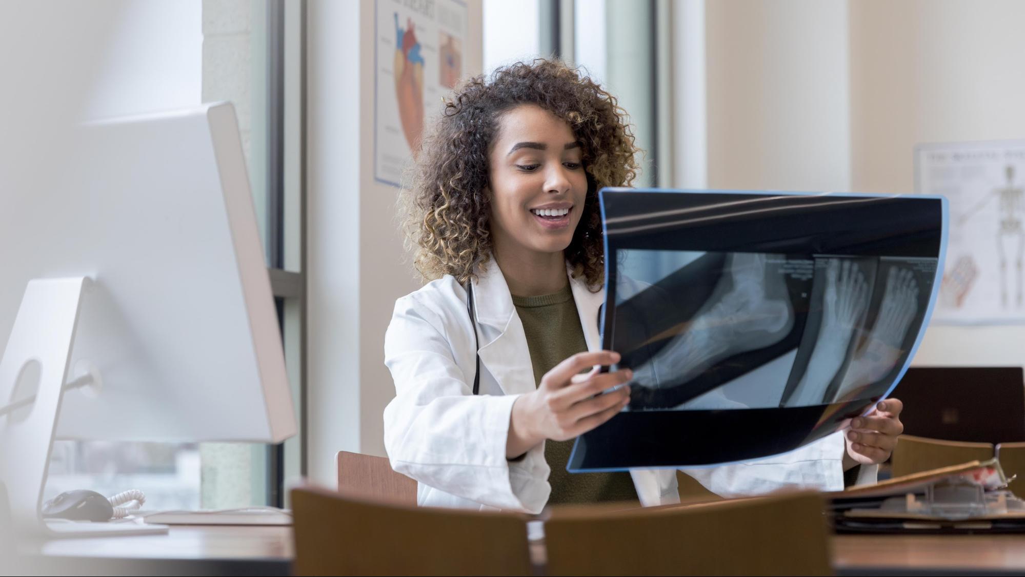 Podiatrist looking at x-ray of patient’s foot