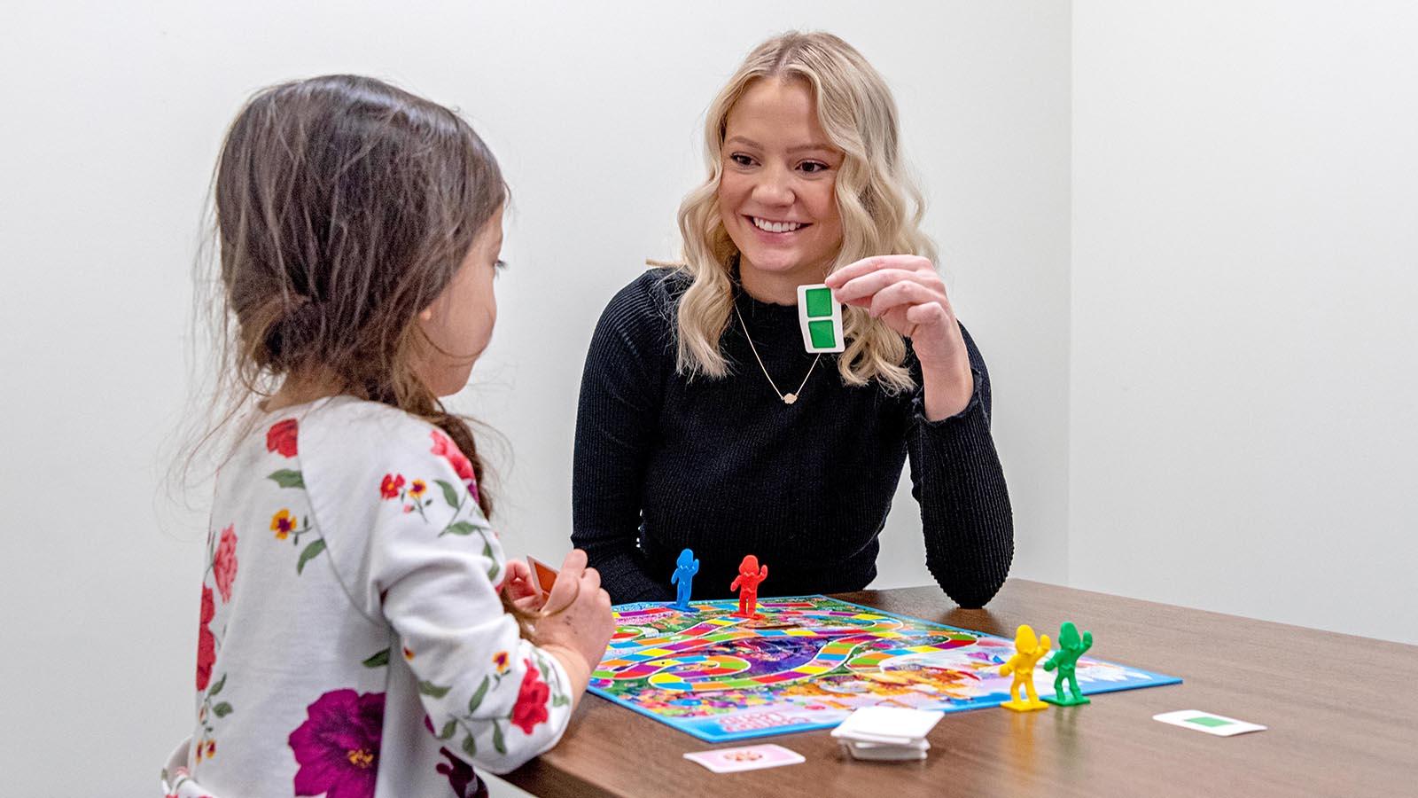 Speech-language pathology student working with a child.