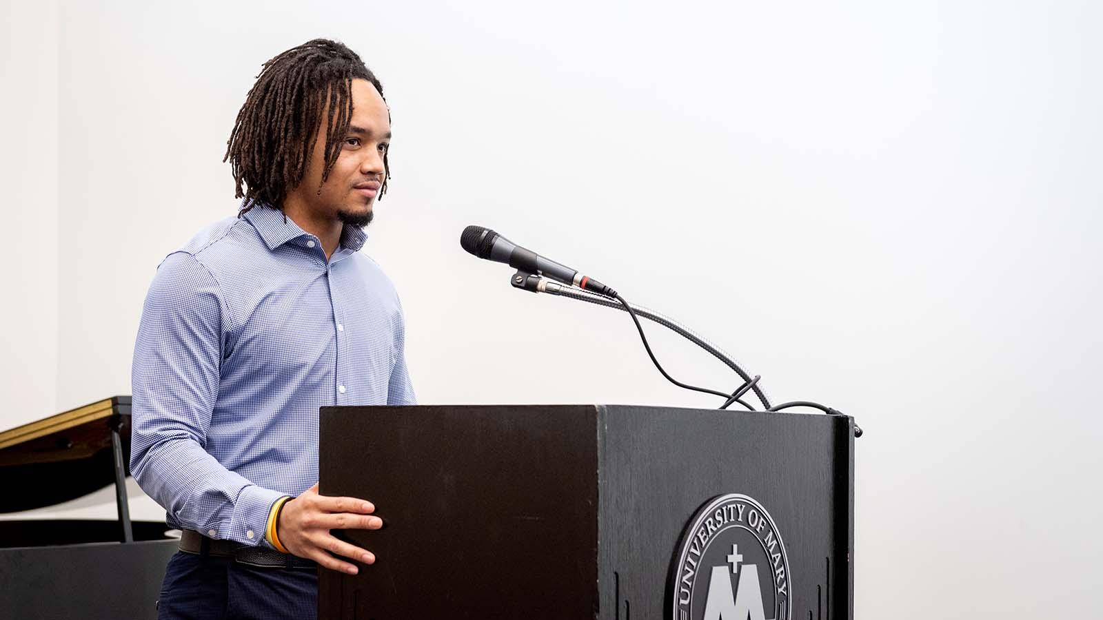 African american student at a podium giving a speech