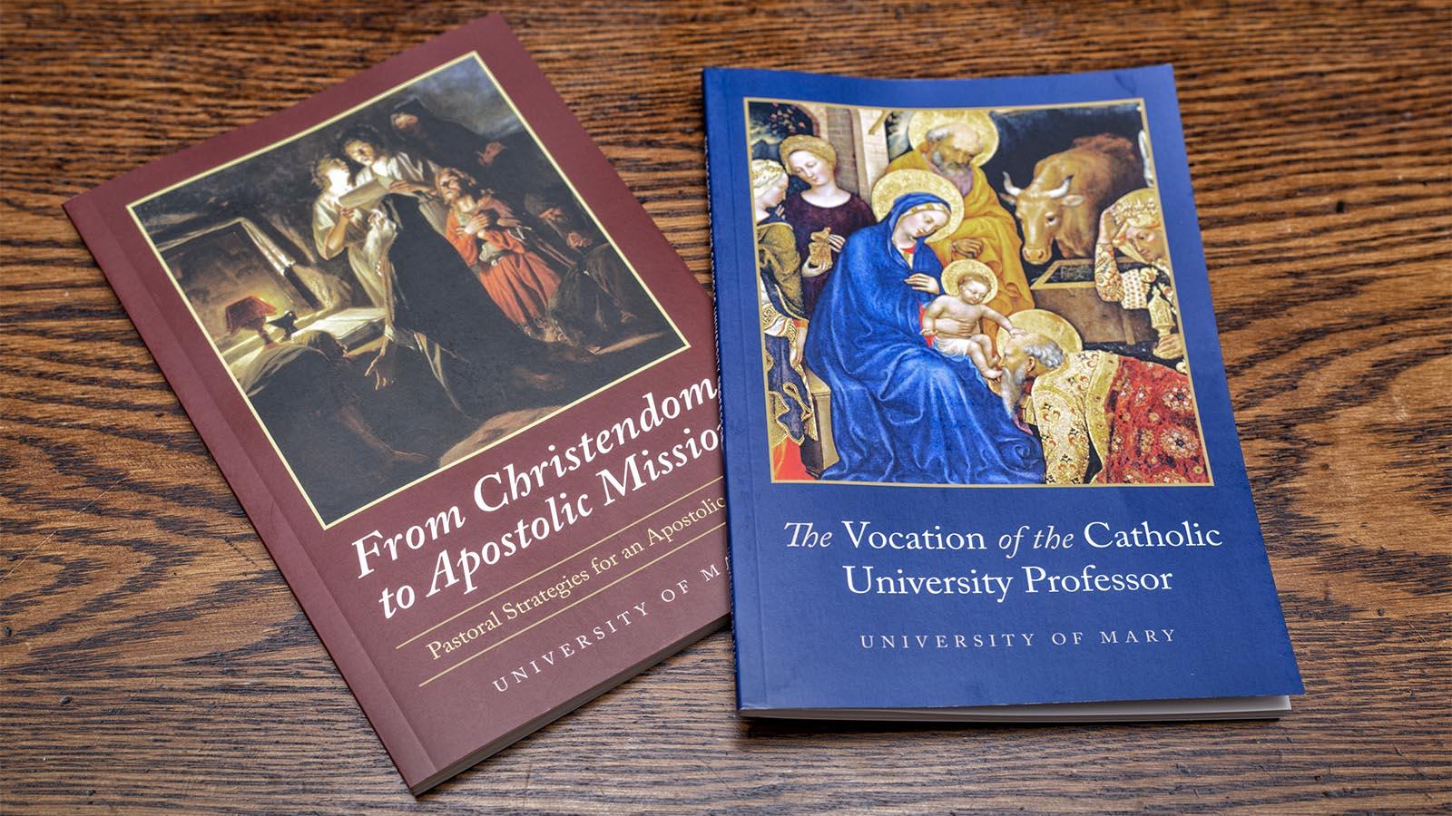 “From Christendom to Apostolic Mission” and “The Vocation of the Catholic University Professor” laying on a wooden table.