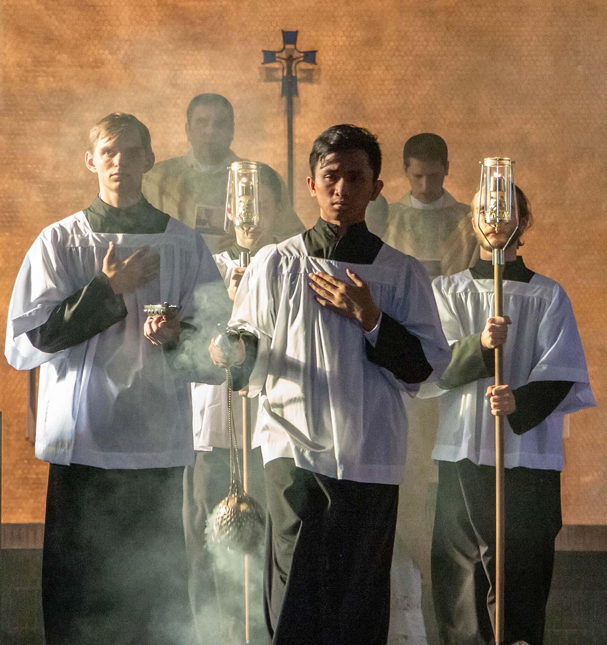 Altar servers leading Mass recessional with incense