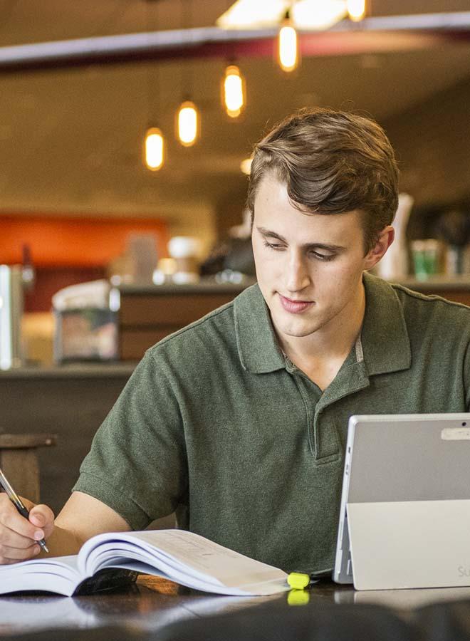 Adult student studying at the a coffee shop