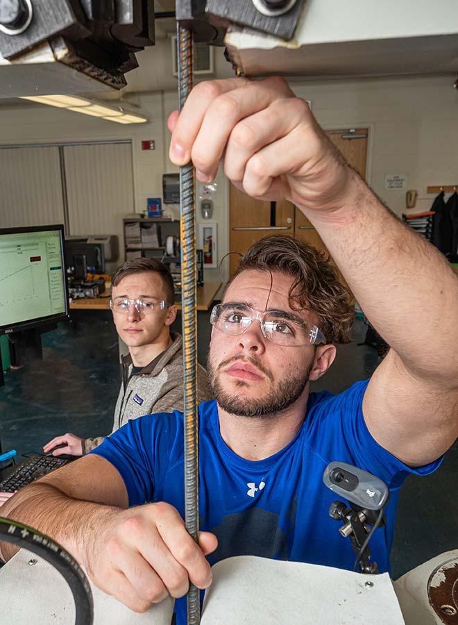 Engineering student cutting rebar