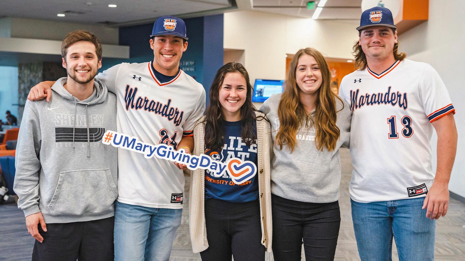 Students holding a Giving Day sign