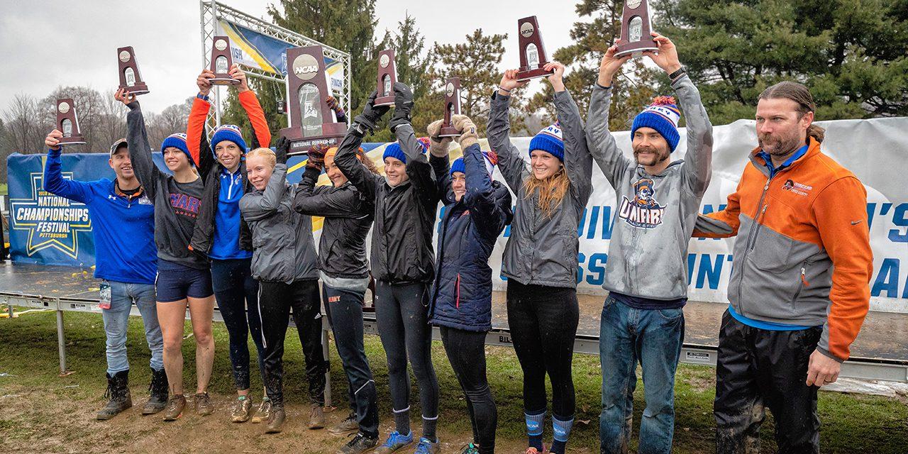 UMary Women’s Cross Country Team holding their trophies