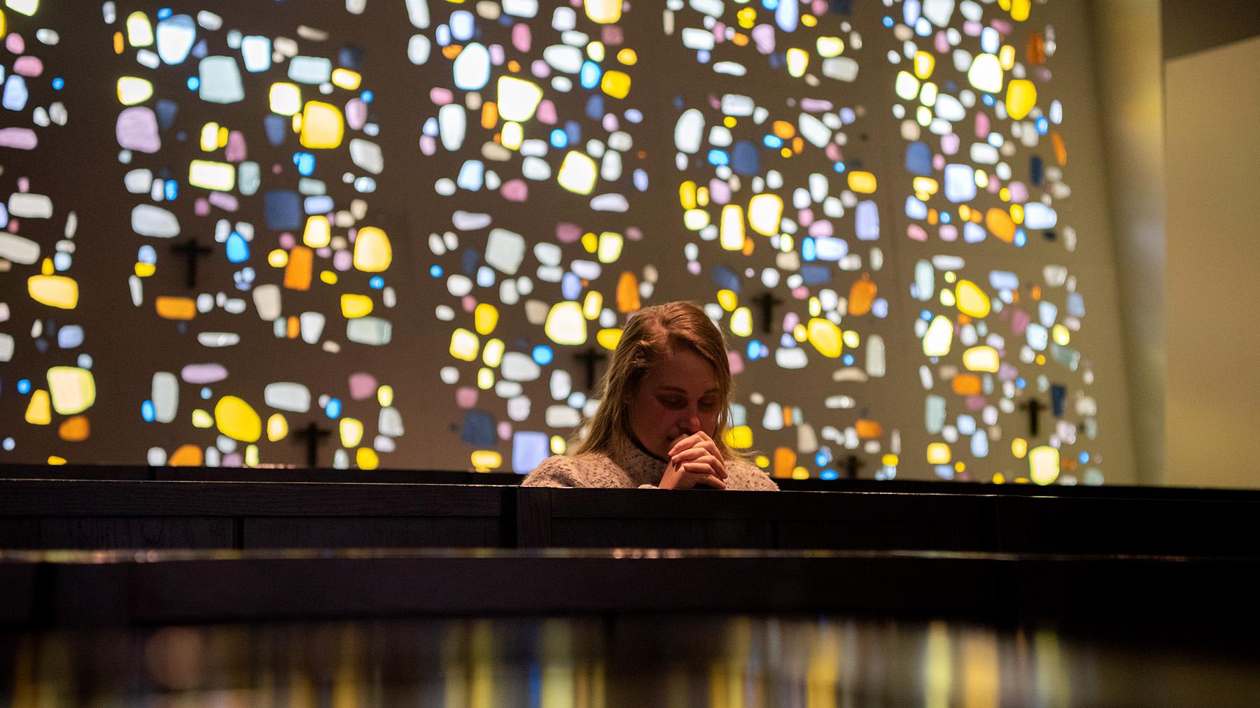 Student Praying in Annunciation Chapel