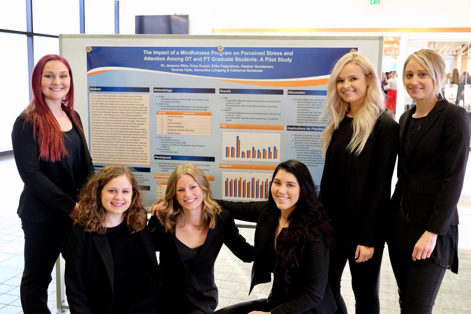 Students standing in front of their science board