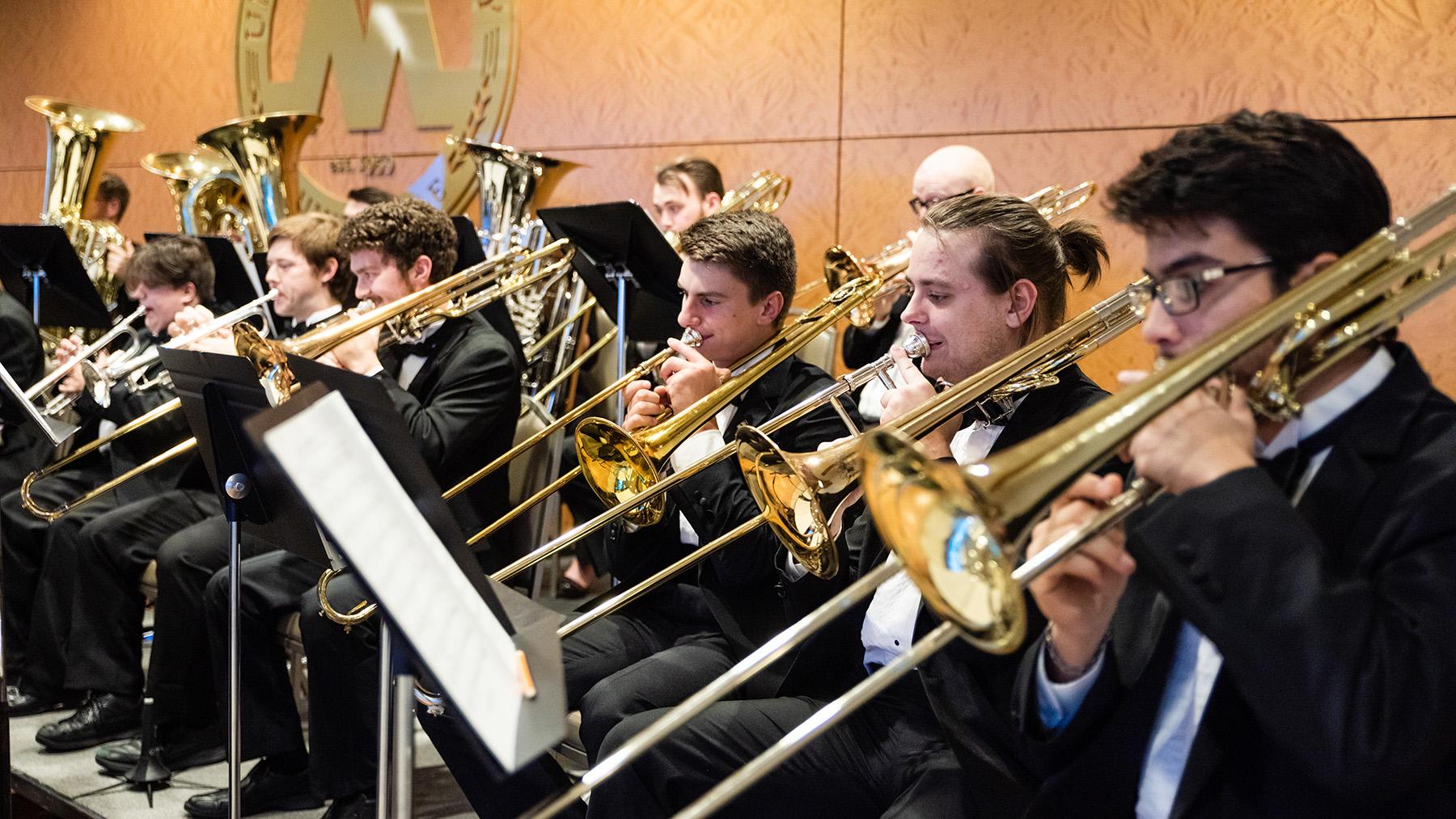 Band student playing the brass instruments