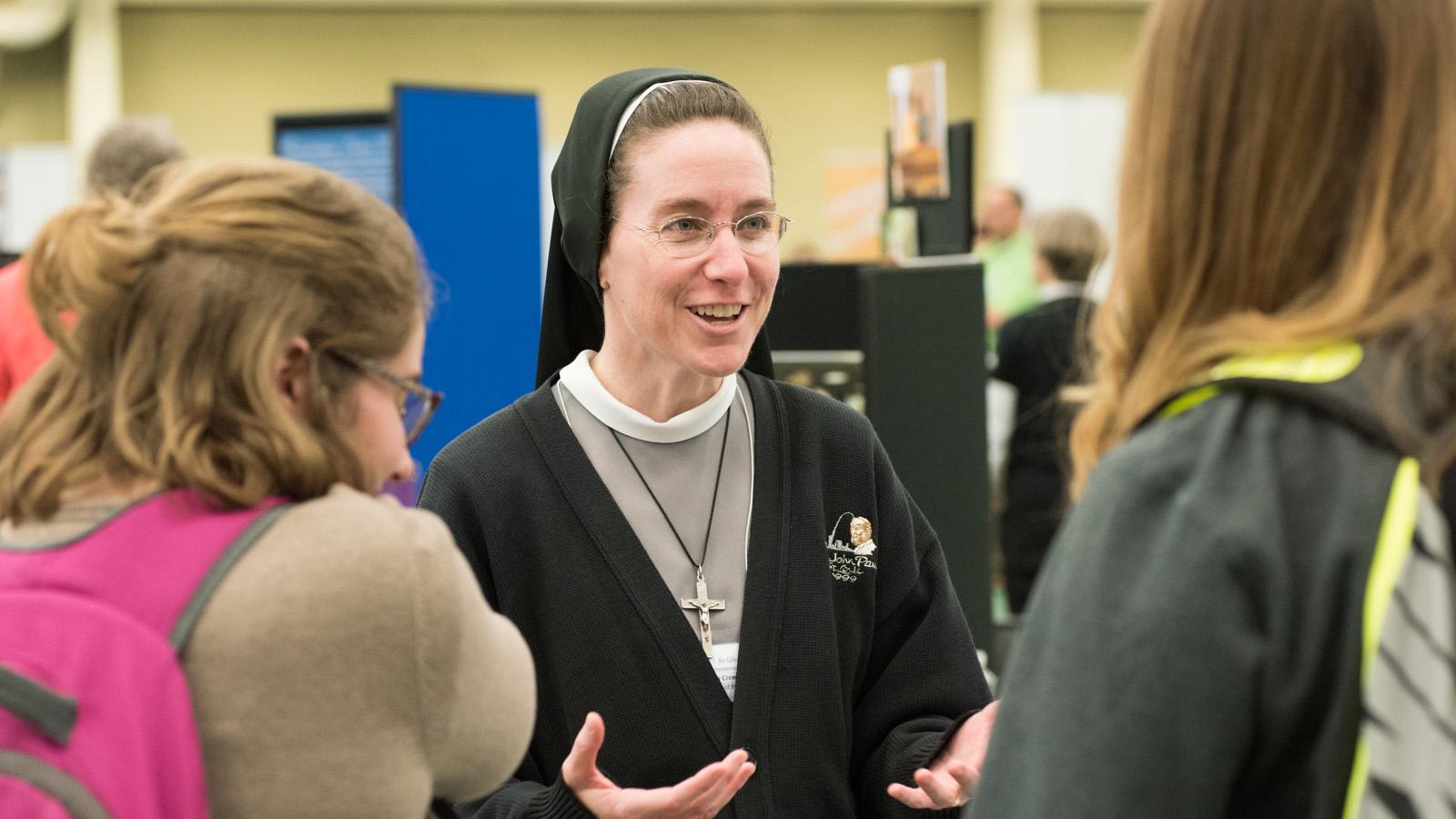 Sister talking to students