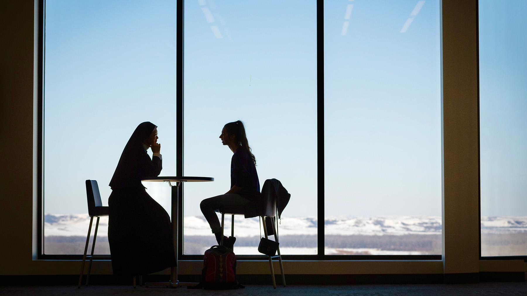 Sister and Student silhouette sitting in Chicks Place