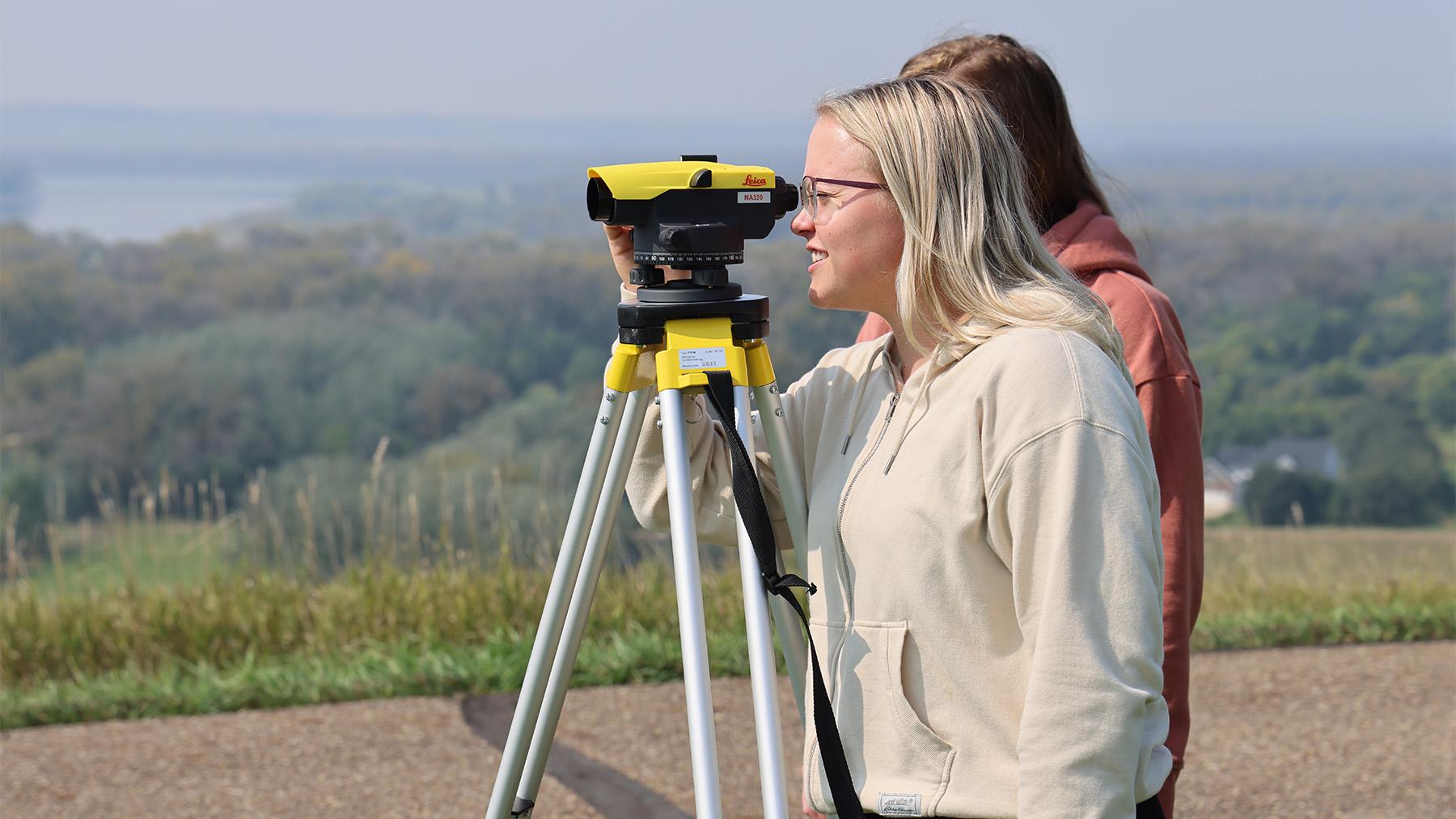 Students doing surveying work outside