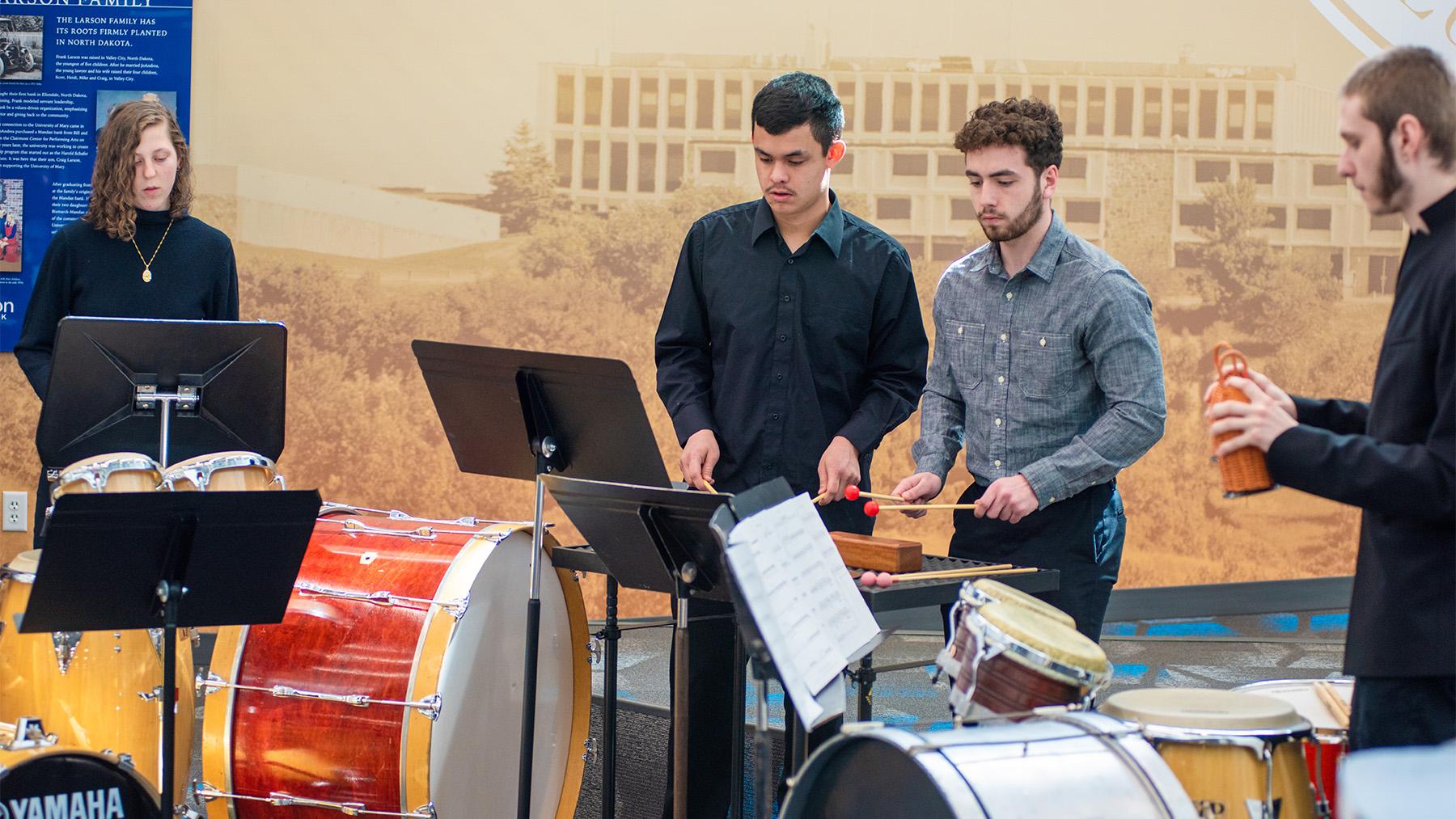 Students playing precussion instruments in the Lumen Vitae Center