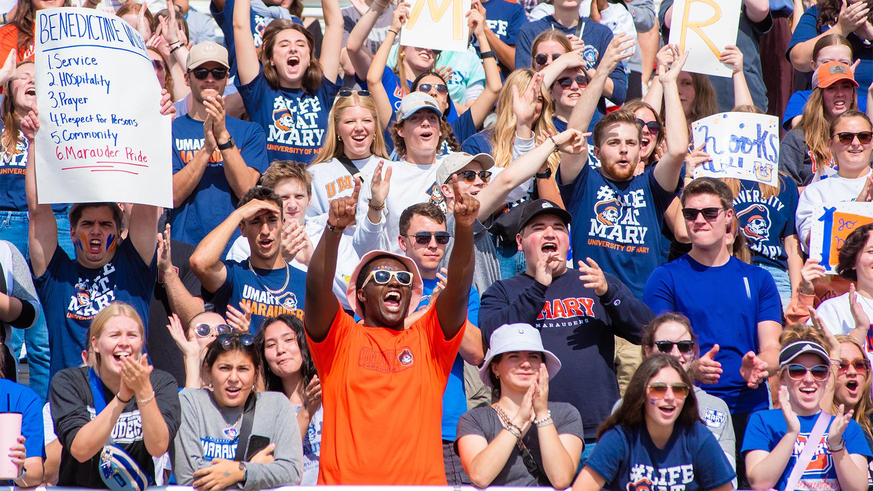 Marauders fans cheering at a football game.