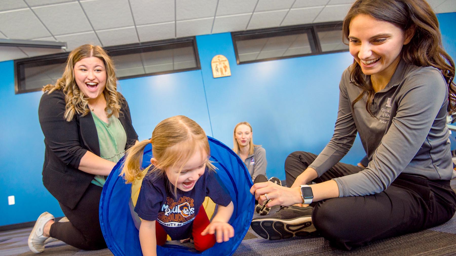 Physical Therapy students with child