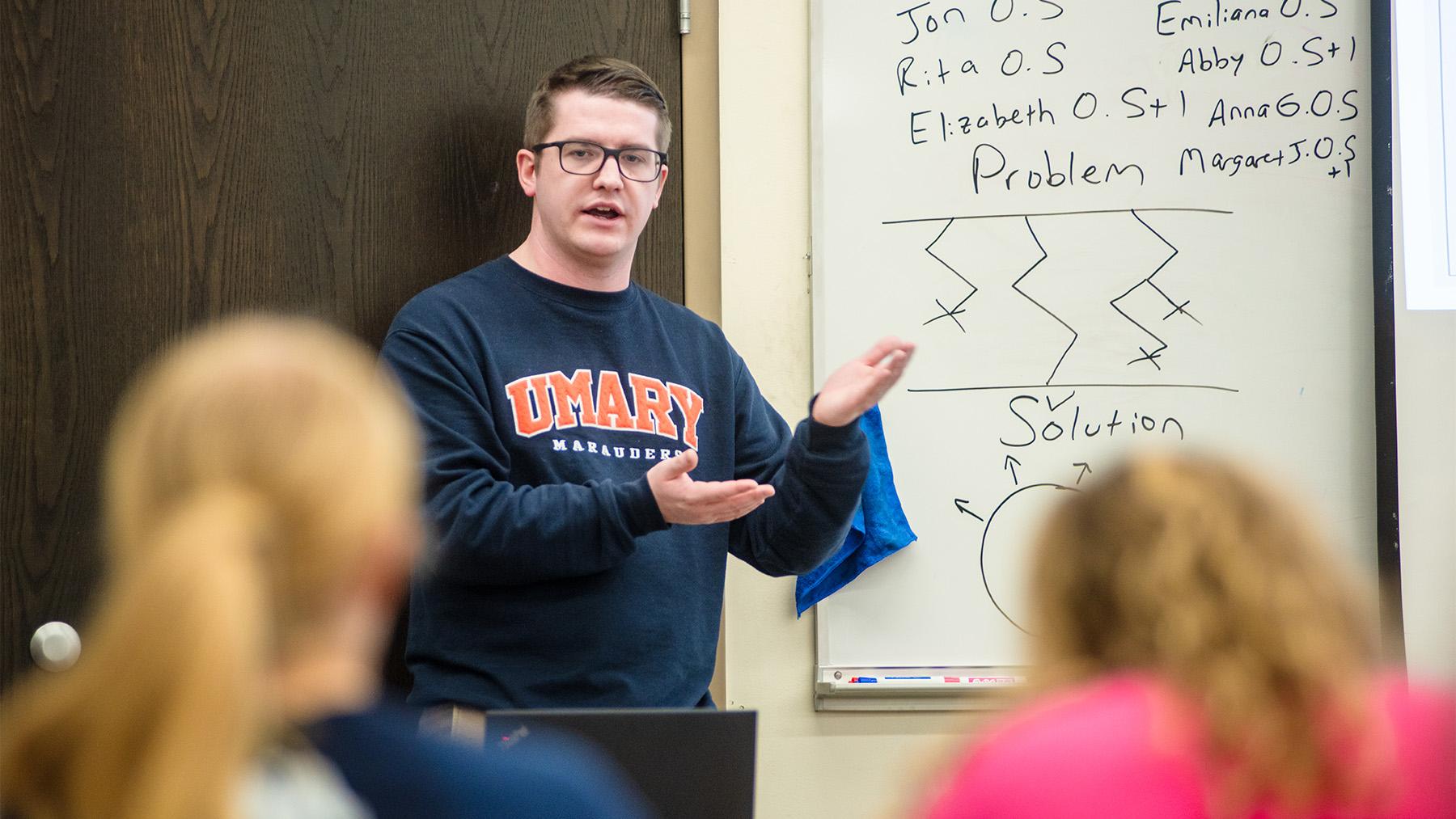 A Math Teaching working through a problem with students in class.