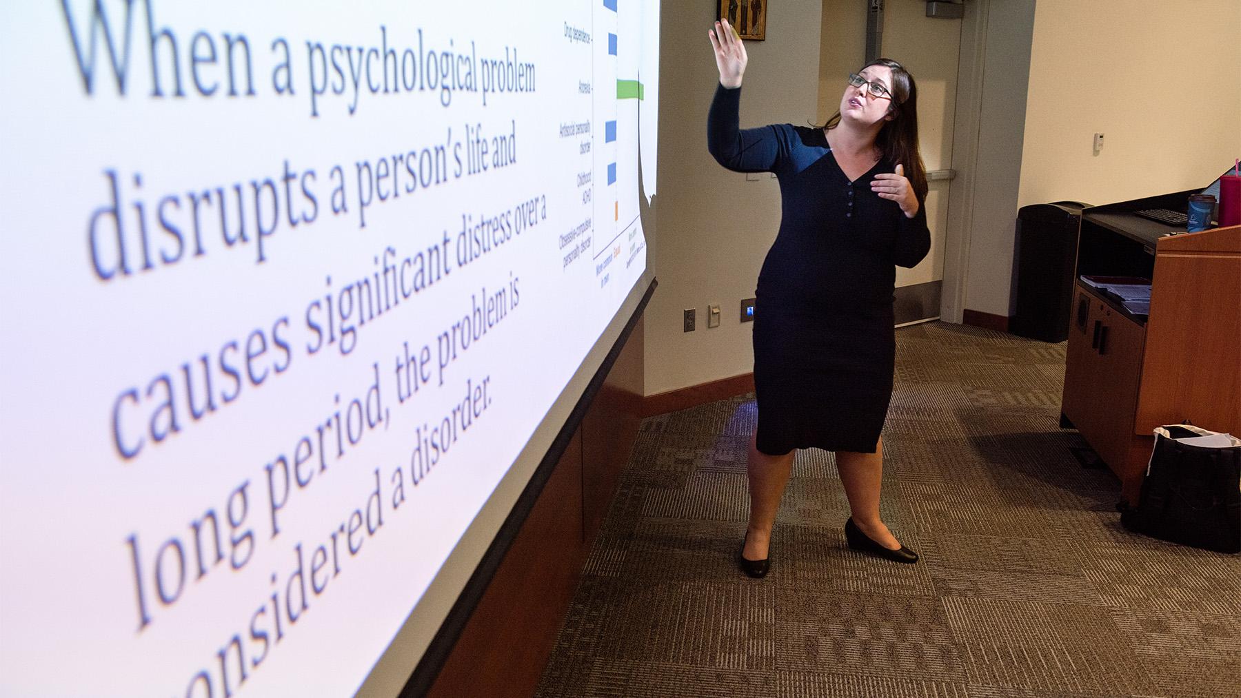 Teacher in a Psychology class showing a slideshow.