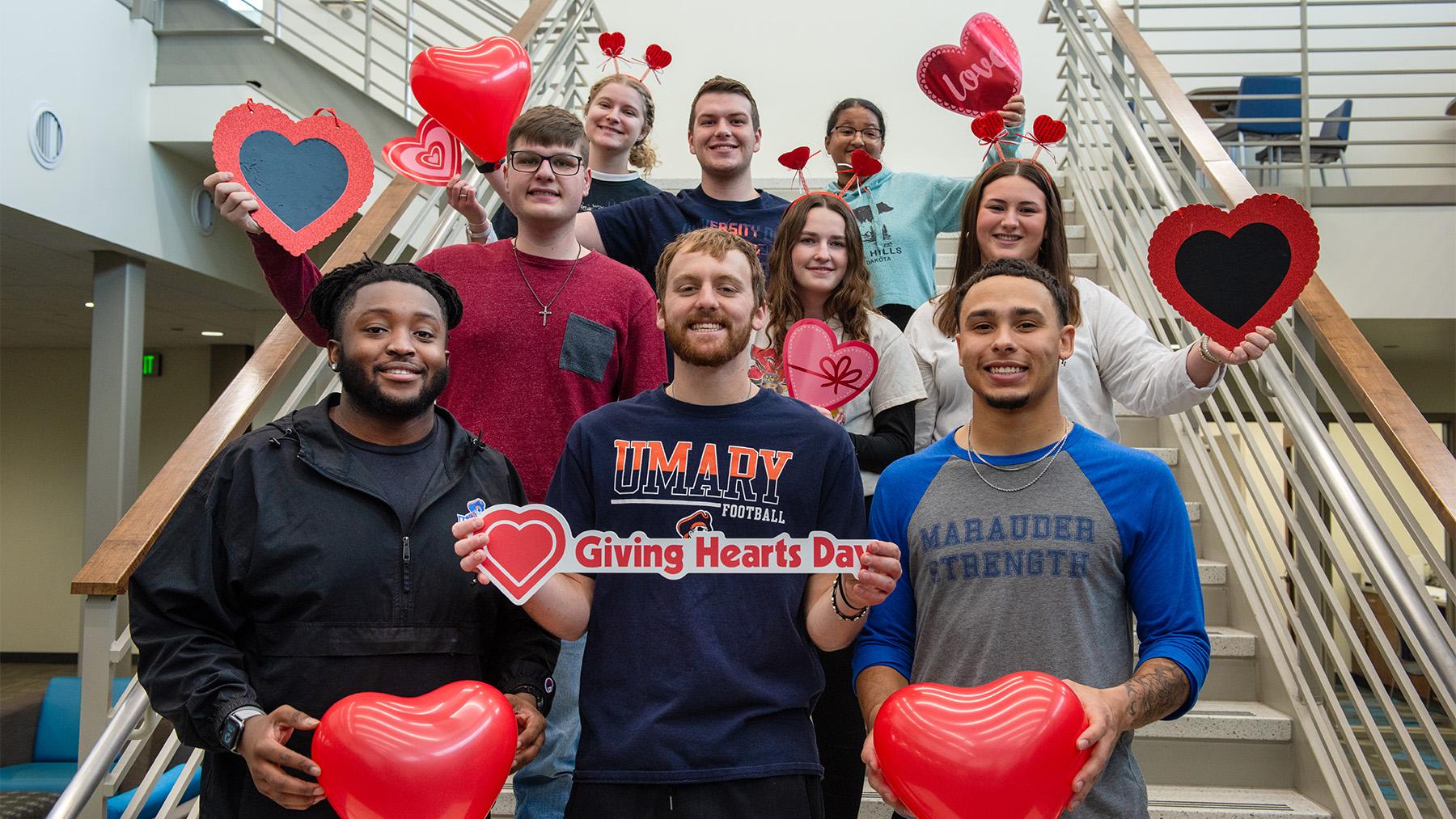 Students with hearts on the staircase