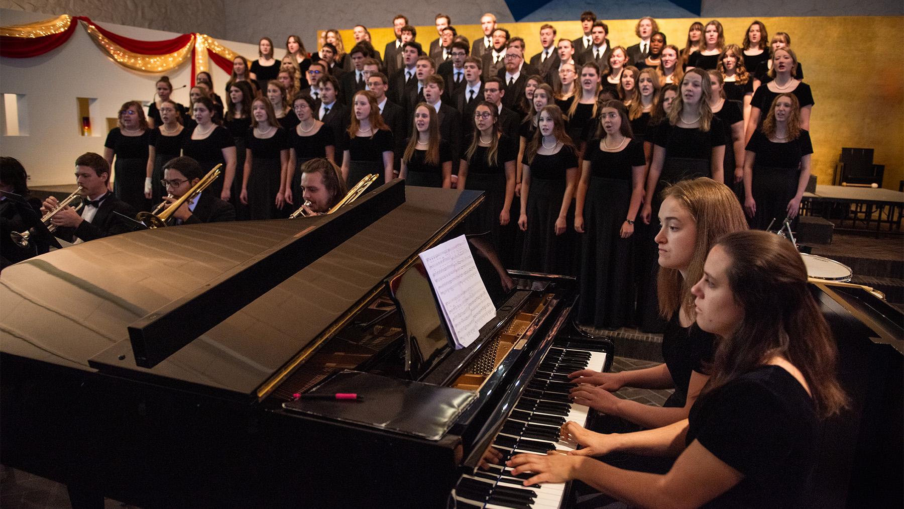 The Choir sining in Our Lady of Annunciation Chapel with the piano playing and brass instraments.