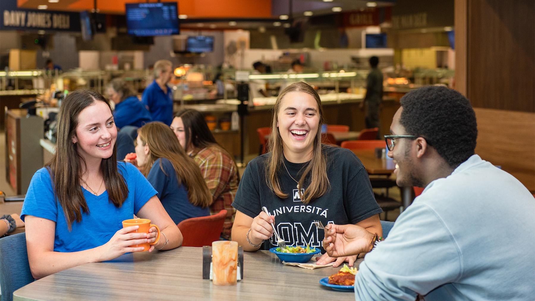 Students having fun with friends while eating at the Crow's Nest