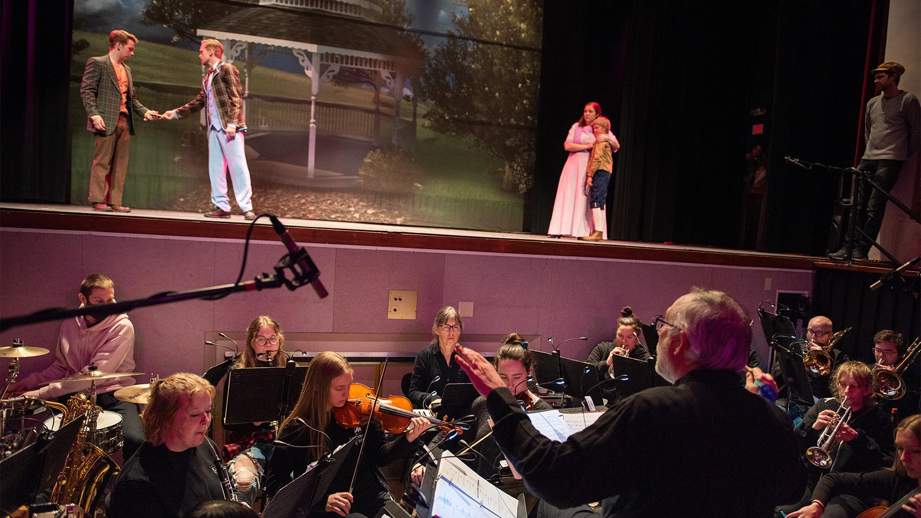 Students in the Music Man with a full orchestra.