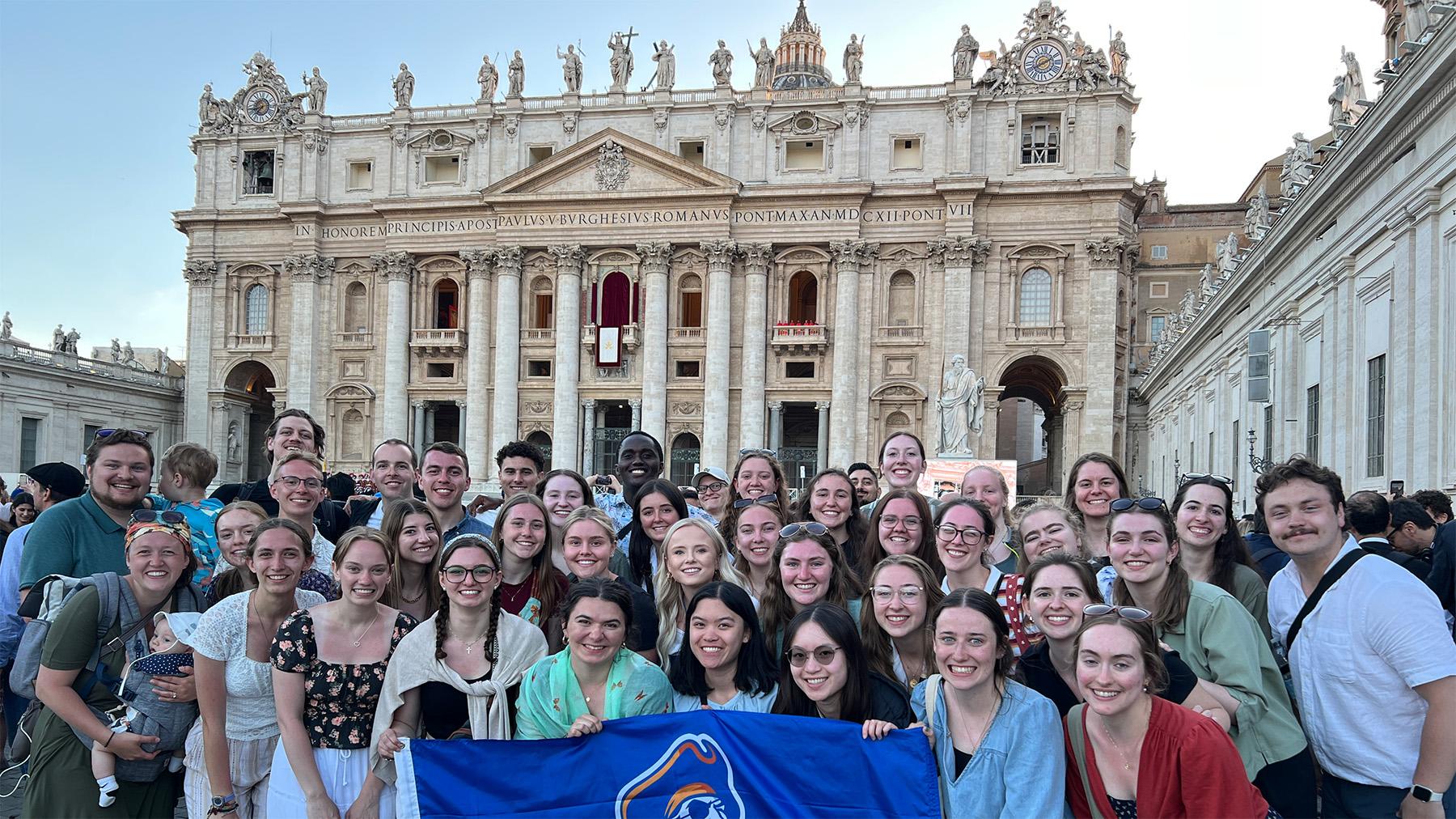students in front of the Vatican waiting for the new pope