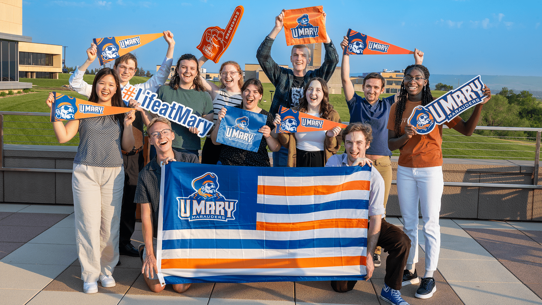 Students showing school spirit with flags and cheering.