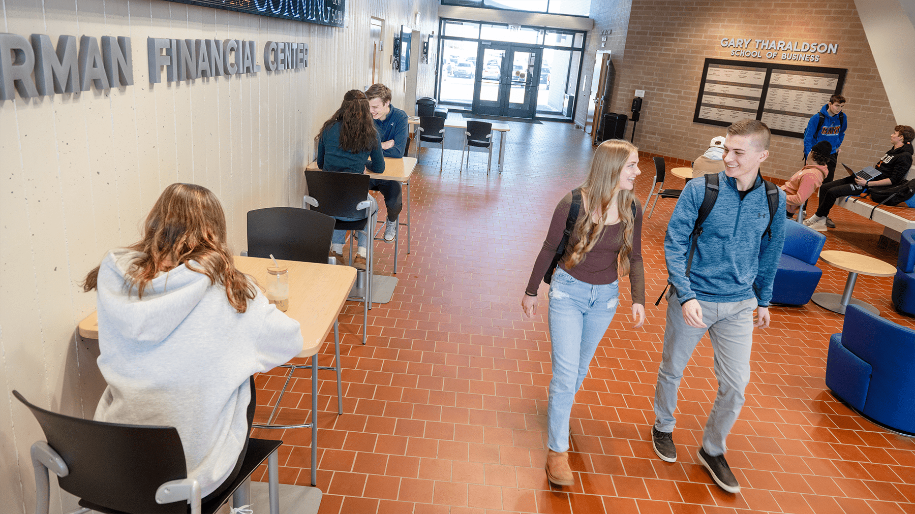 a wide angle shot of the GTSB Lobby with students studying and walking through.