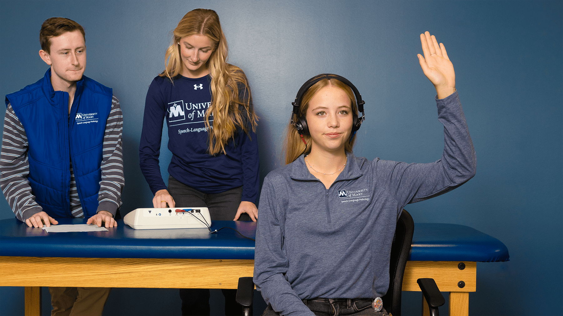 Speech language pathology students practicing hearing testing.