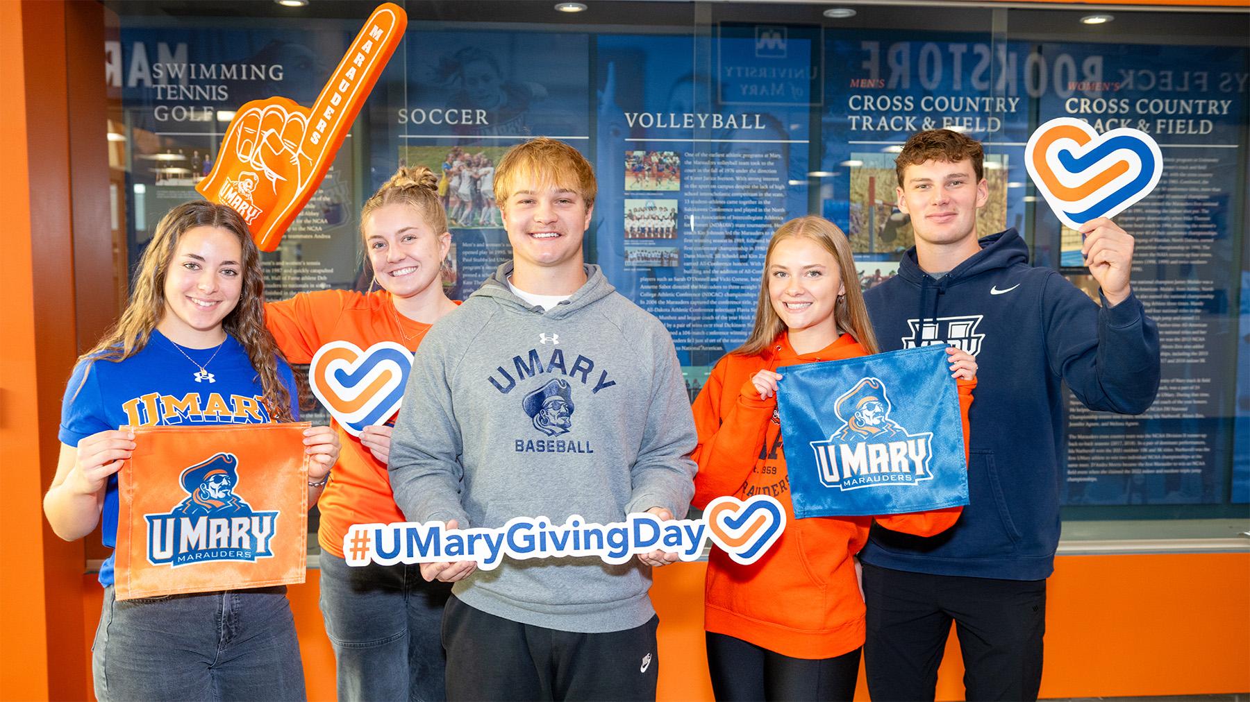Students celebrating giving day with signs