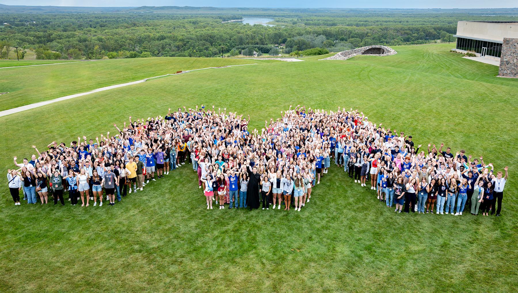 Freshman class of 2025 standing in the M