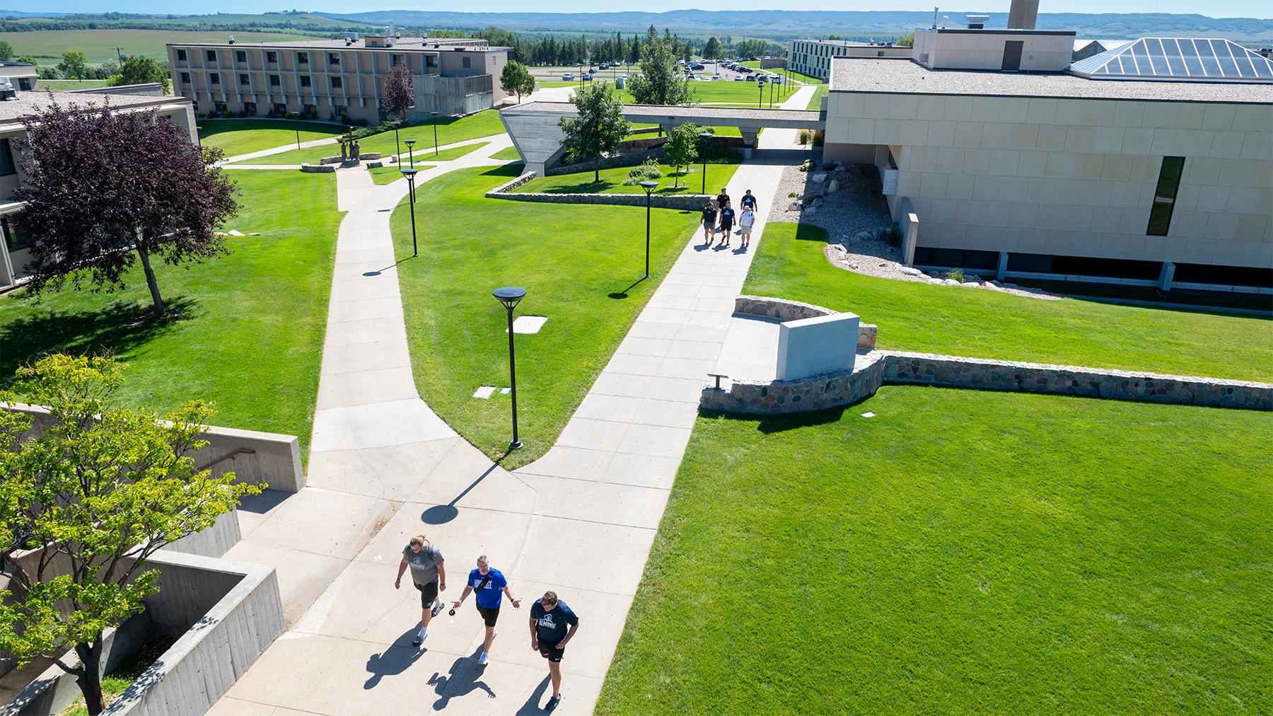 an aerial view of the library and residents halls with students walking on the pathways.