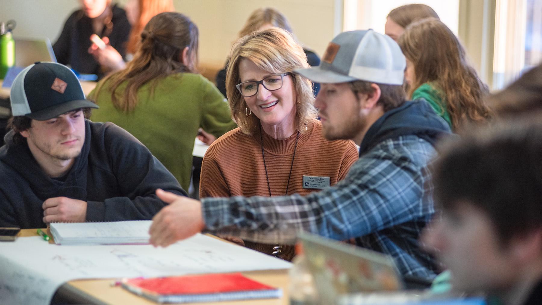 Carmain Cain working with students on a class project