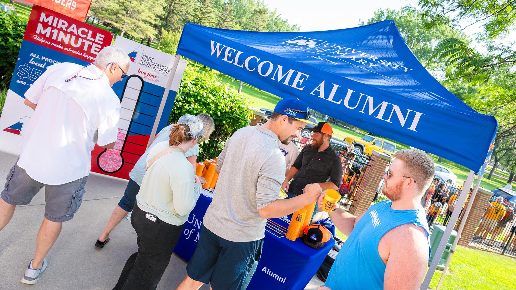 Alumni at the event booth