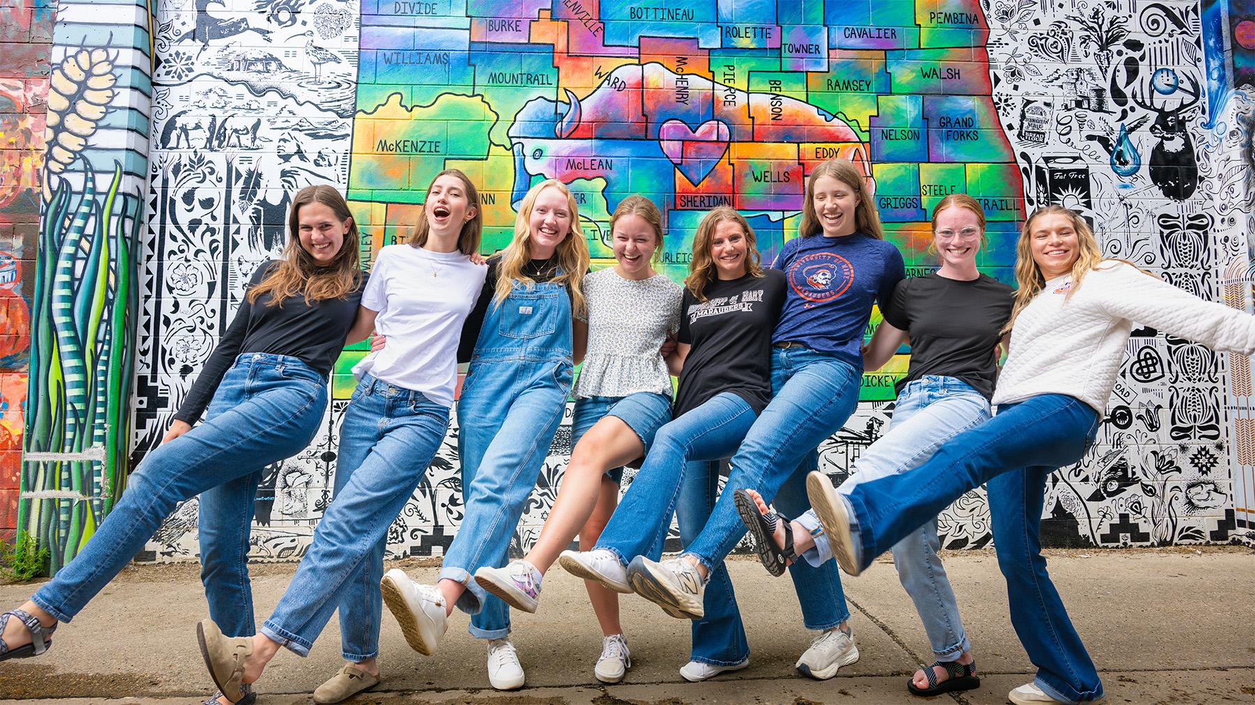 students in front of the North Dakota state Mural in Gallery Alley
